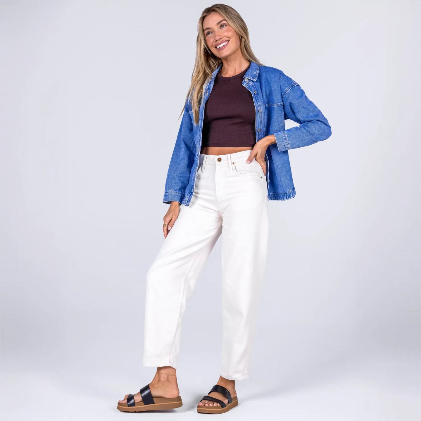 Woman standing wearing black Vista Hi 2 sandals facing forward, showcasing lightweight, arch support, and beach-inspired comfort.