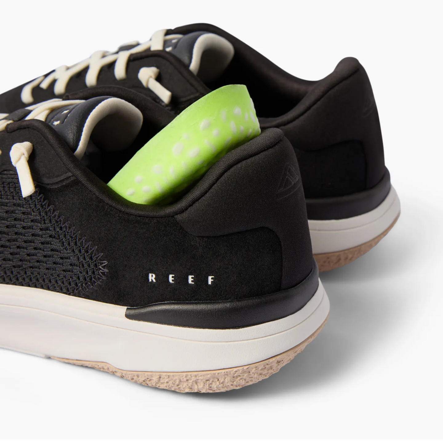 Rear view close-up of black Reef Del Mar shoes with visible cushioning insert, showcasing comfort and durable design.