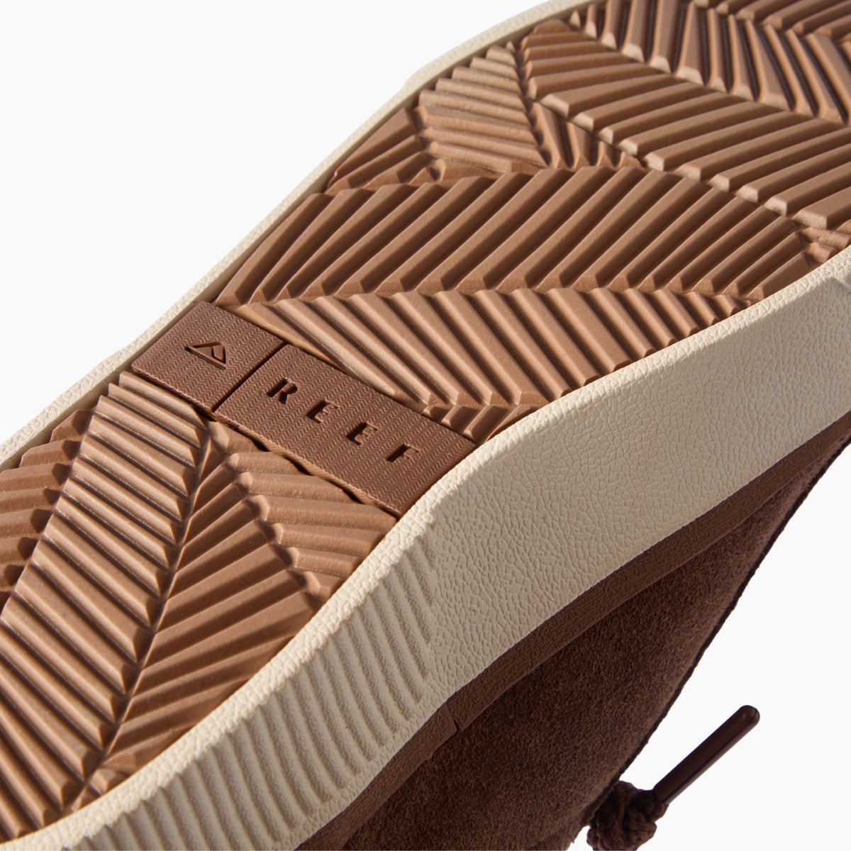 Lay Day Dawn sneaker outsole facing the camera in close-up, showing textured tread and REEF branding