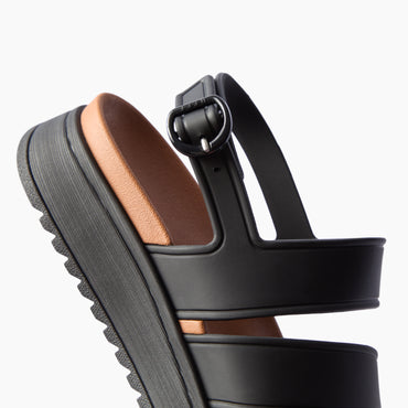 Vista Marbella black sandal facing right in close-up side view with buckle straps and textured platform sole