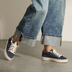 Lay Day Lite navy sneakers with white laces, one facing right and one facing left, shown with cushioned soles for everyday comfort