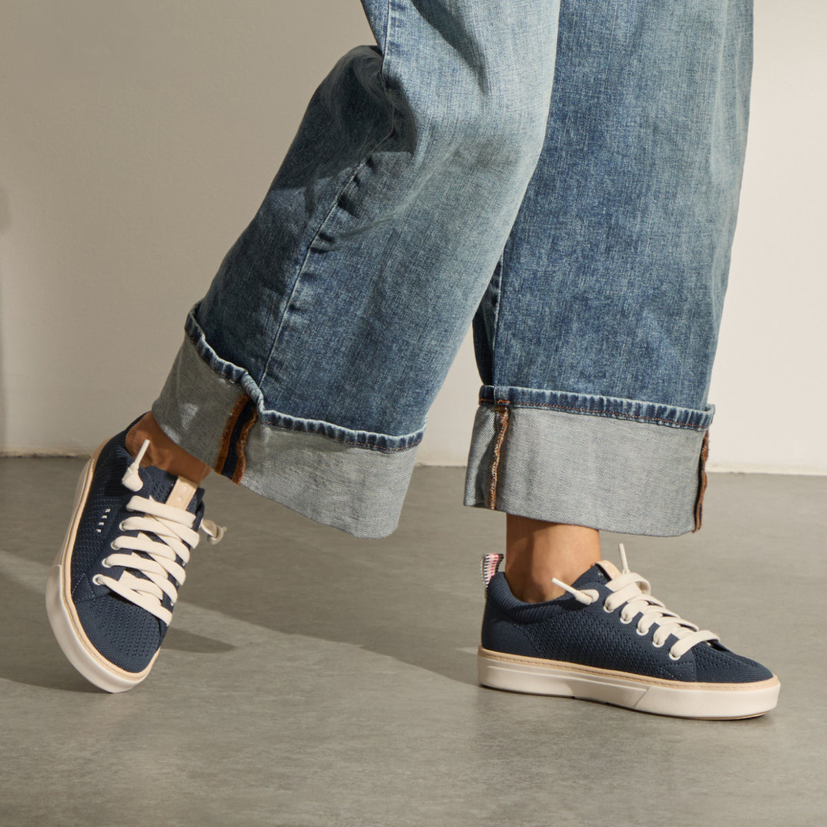 Lay Day Lite navy sneakers with white laces, one facing right and one facing left, shown with cushioned soles for everyday comfort