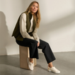 REEF Lay Day Lite white sneakers worn by a seated woman, toes angled forward for everyday comfort