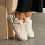 Lay Day Lite white sneakers facing forward and slightly right in a close up view with cushioned soles