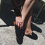 Woman wearing black Vista Myra facing forward, slip-on clog with suede upper, cushioning, and enhanced arch support for comfort.