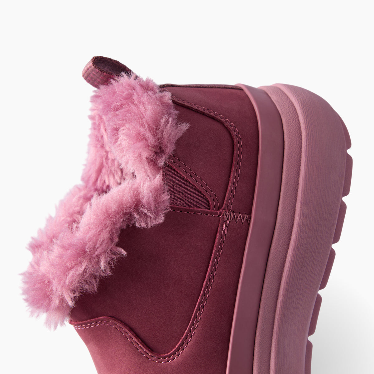 Weekend Olivia pink boot facing left in a close up side view with plush faux fur lining and a cushioned sole