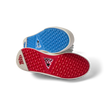 Onshore Pebble X Palm men's shoes soles facing up, showing durable red and blue gripped outsoles for beach comfort.