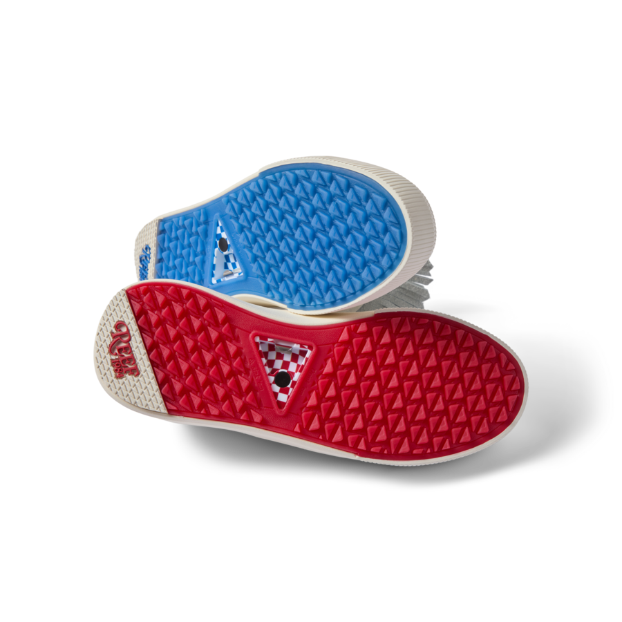 Onshore Pebble X Palm men's shoes soles facing up, showing durable red and blue gripped outsoles for beach comfort.