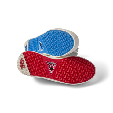Onshore Pebble X Palm men's shoes soles facing up, showing durable red and blue gripped outsoles for beach comfort.