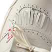 Close-up of the top front of the Onshore Pebble X Palm sneaker in off-white with soft leather and detailed stitching