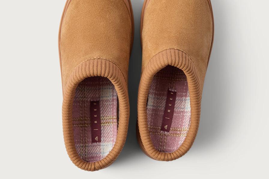 Top view of tan slip-on shoes facing upward, showing ribbed collars and patterned footbeds