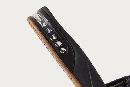 Close-up of the black REEF sandal heel with visible air-cushion support, highlighting comfort features and durability.