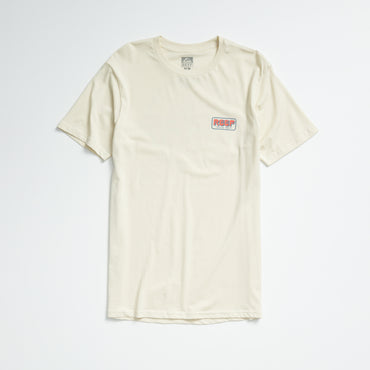 Quinn Tee in almond milk color, laid flat showing front with small REEF logo on chest, lightweight comfort apparel.