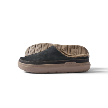 Rambler Mule facing left, showing side profile of black suede men’s slipper with tan cushioned sole and soft lining.