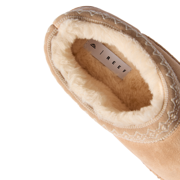 Indie Slipper close-up facing upper left, showing plush fleece lining and cushioned footbed