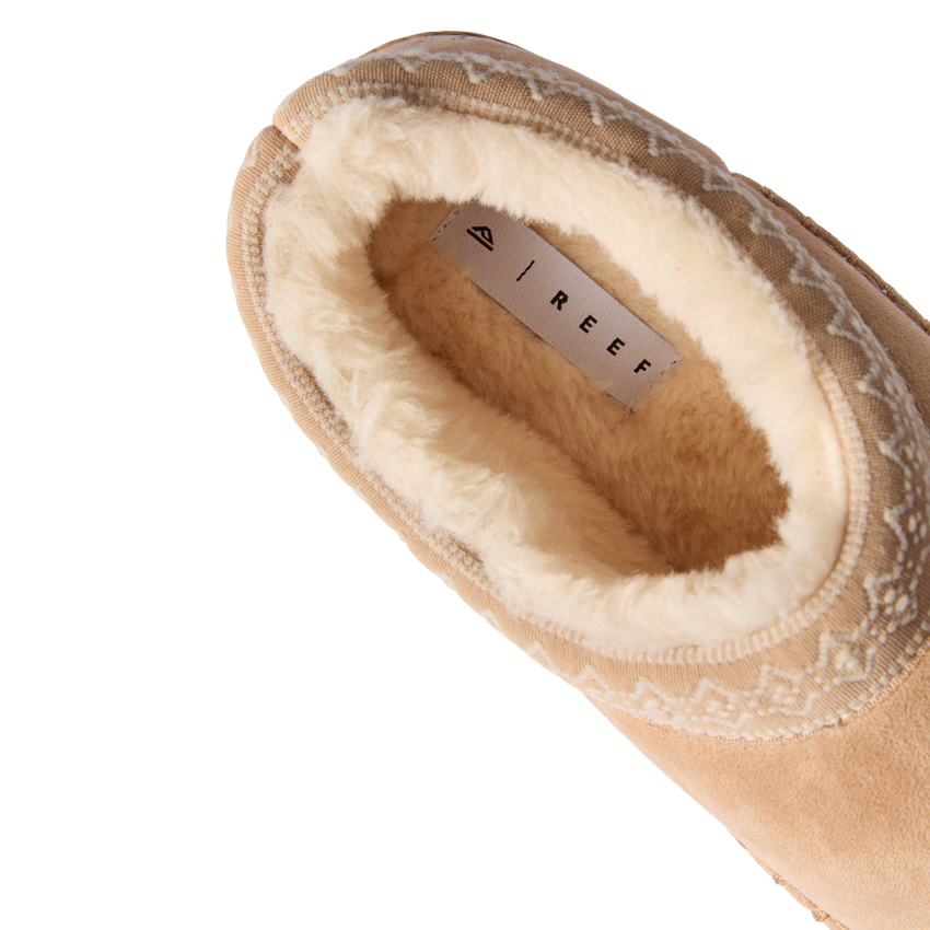 Indie Slipper close-up facing upper left, showing plush fleece lining and cushioned footbed