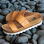 Pair of Cushion Vista Hi sandals faced left, close-up of upper straps and cushioned footbed on smooth stones.
