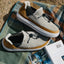 Rambler suede shoes facing right on a blanket, showing cozy terrycloth lining and cushioned white soles