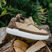 Rambler tan suede shoe facing right on a log with a cushioned white EVA outsole