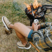Rambler suede slip-on shoes facing left by a campfire, showing cushioned soles and casual outdoor comfort