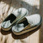 Rambler Kicker slip on mules with toe fronts facing right showing quilted uppers and open heel design