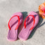 Pink Solaye sandals for women facing upward with red straps and beach-inspired cushioning and arch support