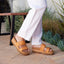 Woman wearing Cushion Vista Higher sandals facing right, showing a close-up of the footbed and straps with arch support.