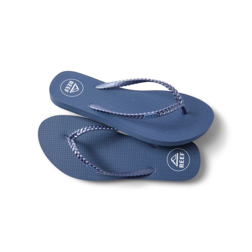 Seaside Twist women's blue flip flops facing right with braided straps, soft cushioning, and anatomical arch support.
