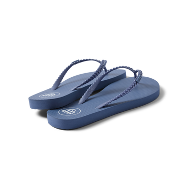 Seaside Twist women's indigo flip flops facing right, showing lightweight, cushioned footbed and braided straps.