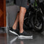 Valle black men's sneaker facing left, close-up of side and sole, lightweight with anatomical arch support.