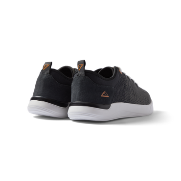 Neso men's black sneakers facing backward, showing heel with anatomical arch support and soft cushioning.