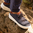 Atlantic men's sneaker facing right on rocky surface, navy and cappuccino with cushioned sole designed for beach comfort.