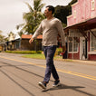 Man walking on street wearing Atlantic shoes facing right, featuring comfort and surf-inspired design in navy and cappuccino colors.