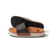 Sydnee Cutback Low women's black and tan slide sandals side view showing soft-rebound cushioned footbed and textured outsole