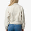Woman wearing a cream Sammie Sherpa Jacket showing the back, highlighting soft, comfort-focused apparel design.