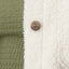 Close-up of the Sammie Sherpa Jacket showing the green fabric and cream sherpa with a branded REEF button detail.