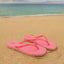 Seaside Square Toe pink sandals facing right on sandy beach with ocean background, designed for comfort and durability.