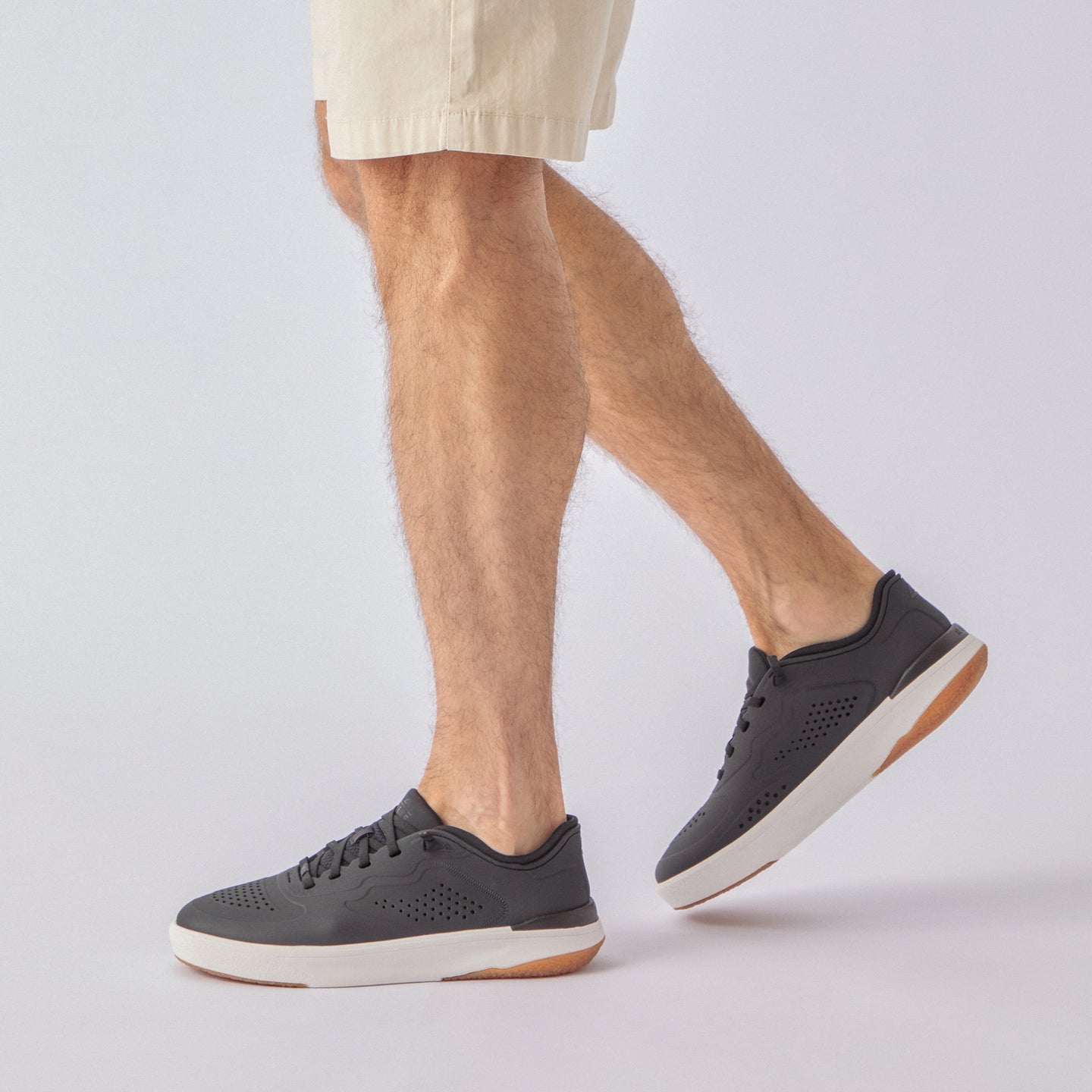 Side view of Shoreline Del Mar H2O black sneakers on foot, showing water-friendly perforated upper and cushioned sole.