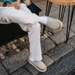 Rambler Mule cream leather mules with toes facing right worn outdoors for everyday comfort