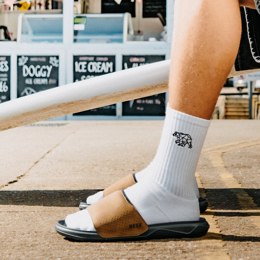 Tailslide mens tan and black slide sandals facing left in side view with a cushioned footbed