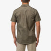 Back view of a man wearing the olive Topaz Shirt, showcasing its comfortable, beach-inspired casual style.