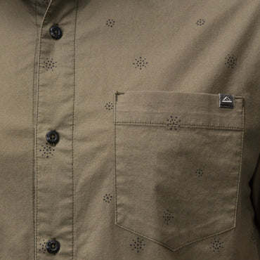 Close-up of the olive green Topaz Shirt pocket with subtle dot pattern and black buttons, beach-inspired comfort apparel.