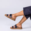 Vista Hi 2 sandal in black facing right, showing side view of cushioned footbed and arch support, worn with casual pants.