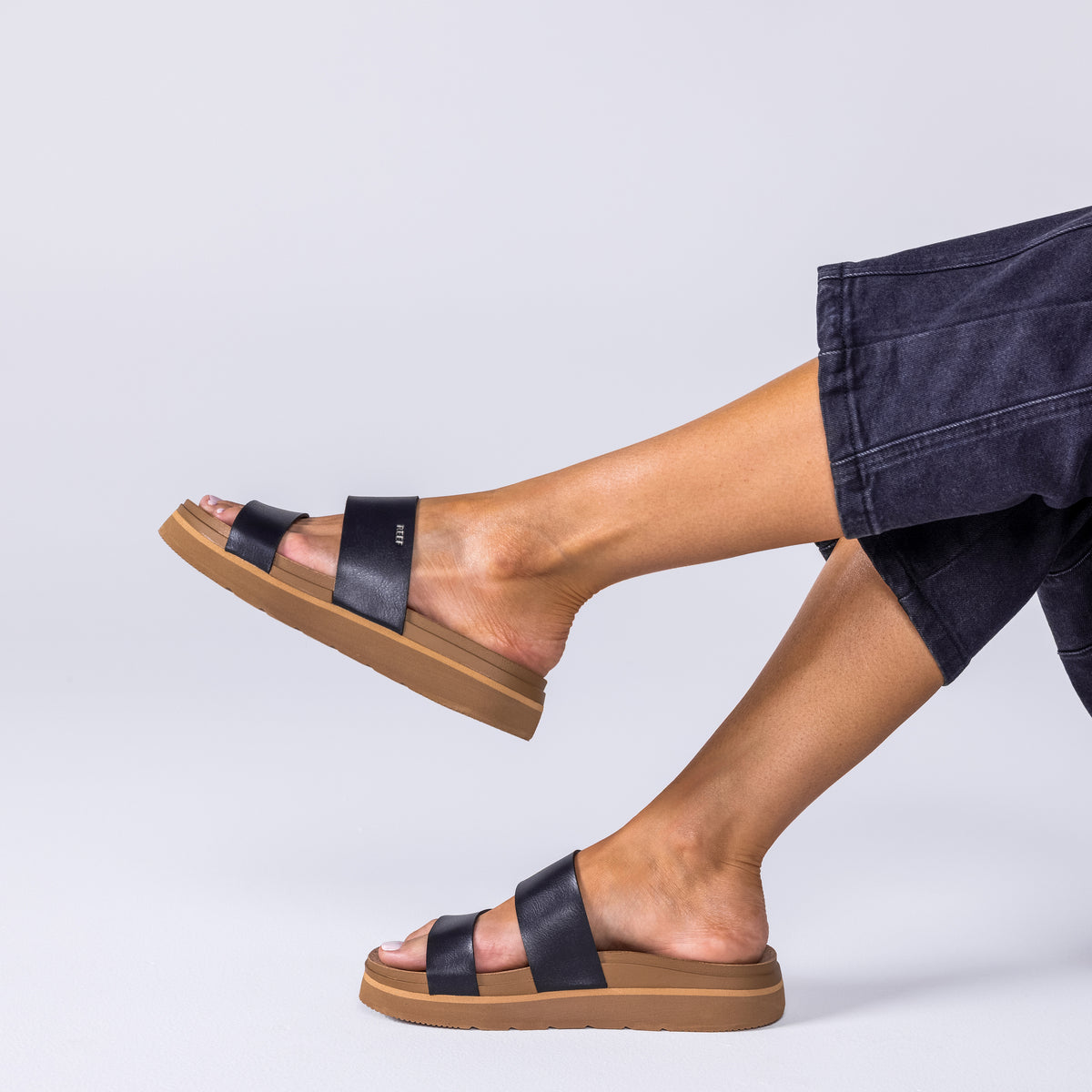 Vista Hi 2 sandal in black facing right, showing side view of cushioned footbed and arch support, worn with casual pants.
