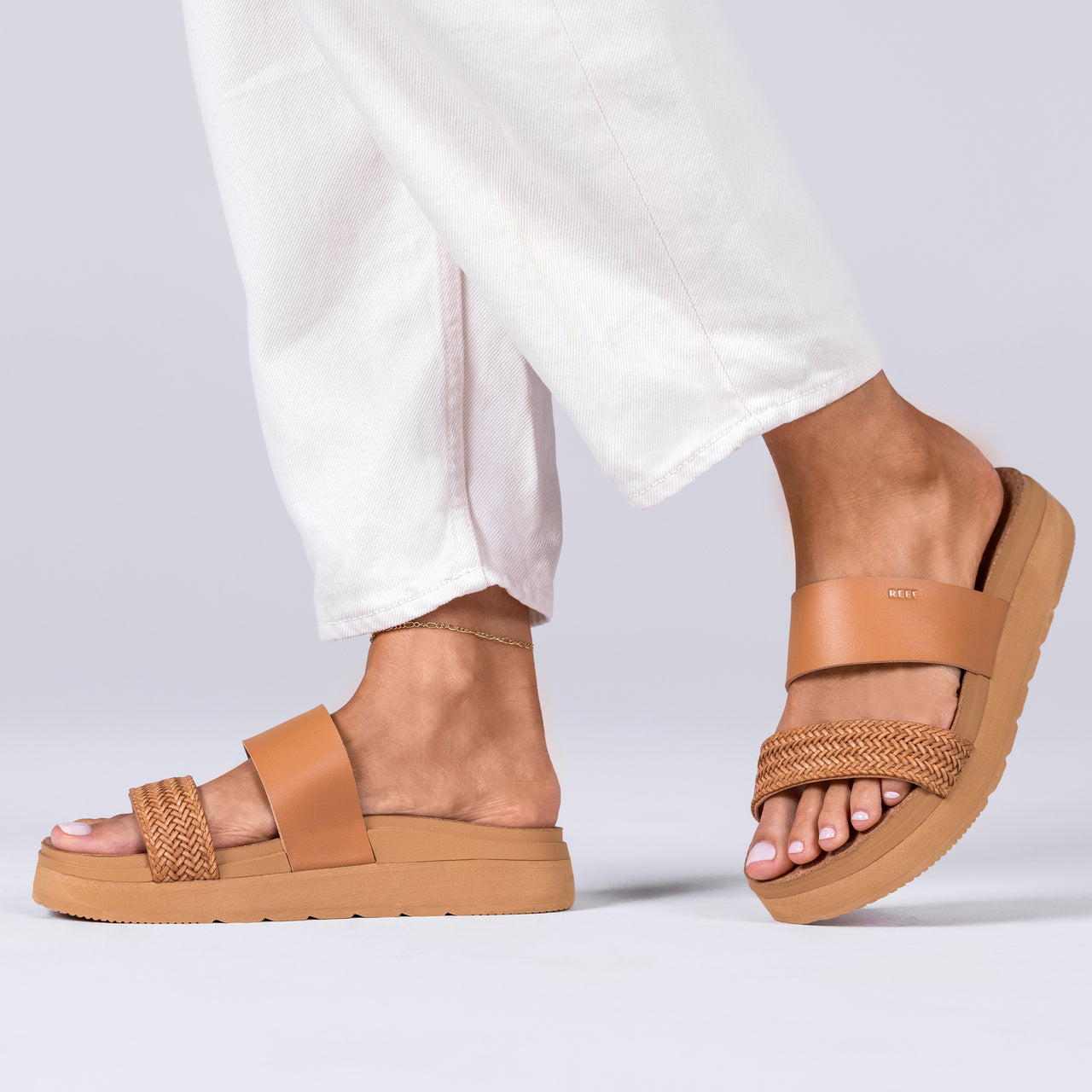 Pair of tan Vista Hi 2 sandals facing right, featuring anatomical arch support and soft braided straps for beach comfort.
