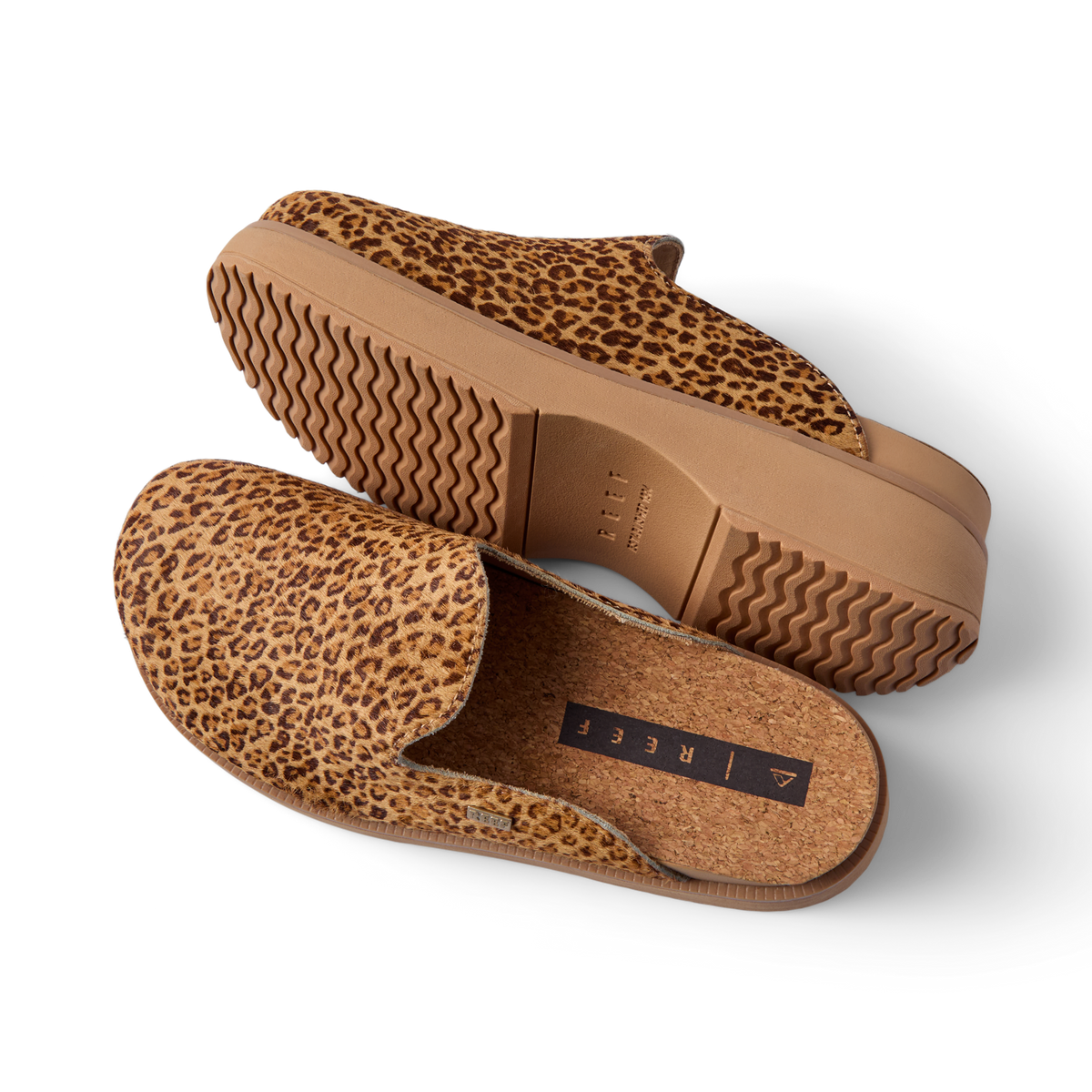 Vista Skye leopard print platform clogs angled left, showing textured uppers, cushioned footbed, and wavy soles