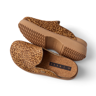 Vista Skye leopard print platform clogs angled left, showing textured uppers, cushioned footbed, and wavy soles