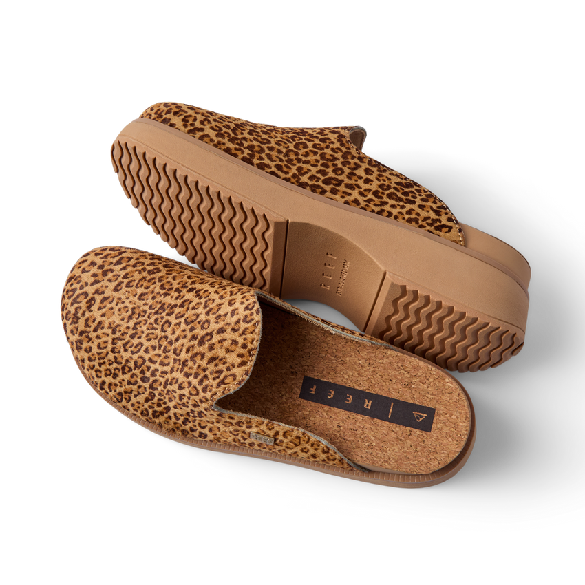 Vista Skye leopard print platform clogs angled left, showing textured uppers, cushioned footbed, and wavy soles