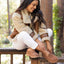 Woman outdoors wearing Vista Skye shoes facing left, showing side and top, highlighting comfortable suede design.