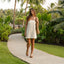 Adult woman wearing Vista Hi Layla sandals facing forward walking on a tropical path, showcasing comfort and beach-inspired style.